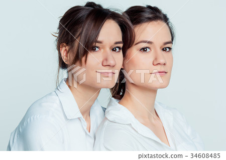 Studio portrait of female twins 34608485