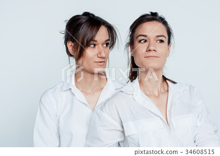 Studio portrait of female twins 34608515