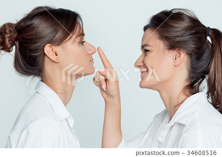 Studio portrait of female twins 34608516