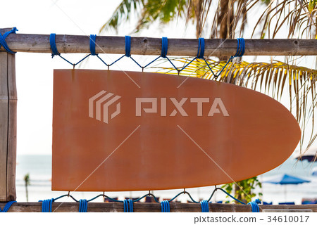 Blank orange signboard in shape of surf board Blank orange signboard in shape of surf board 34610017