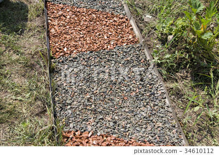 Gravel covered garden path Gravel covered garden path 34610112