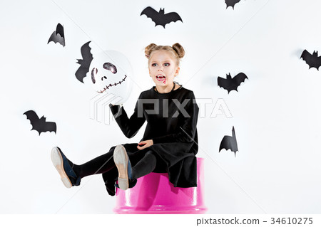 Little girl witch in black dress over magical 34610275