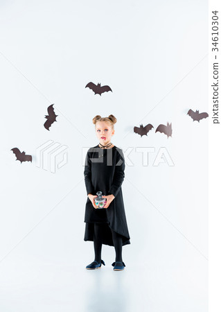 Little girl witch in black dress over magical 34610304