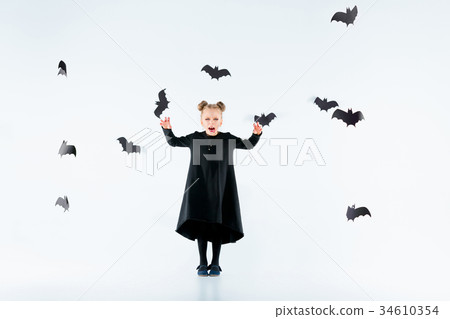 Little girl witch in black dress over magical 34610354