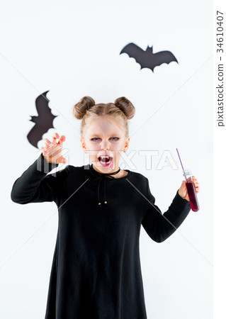 Little girl witch in black dress over magical 34610407
