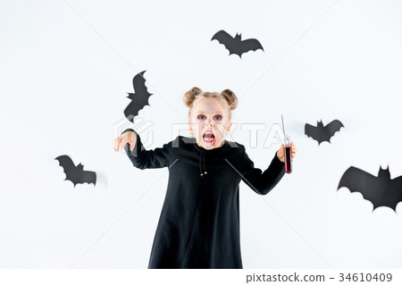 Little girl witch in black dress over magical 34610409