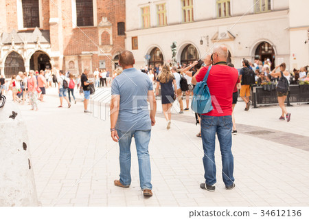 Krakow, Poland. Tourist taking photos in center of 34612136