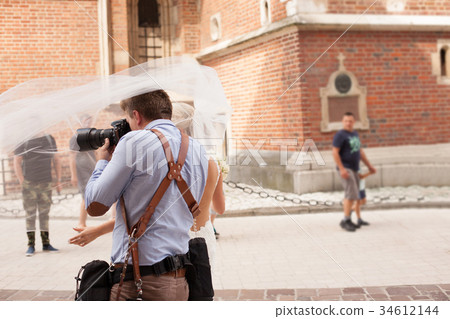 The photographer takes pictures of the bride The photographer takes pictures of the bride 34612144