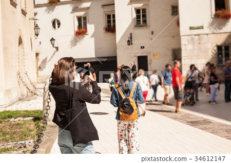 Krakow, Poland. Tourist taking photos in center of Krakow, Poland. Tourist taking photos in center of 34612147