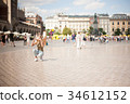 Krakow, Poland. Tourist taking photos in center of 34612152