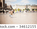 Krakow, Poland. Tourist taking photos in center of 34612155