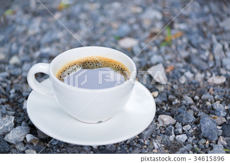 White cup of hot coffee on gray stone ground White cup of hot coffee on gray stone ground 34615896
