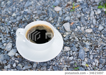 White cup of hot coffee on gray stone ground White cup of hot coffee on gray stone ground 34615897