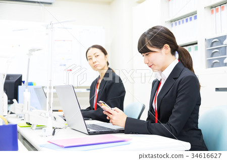使用智能手機OL商人Salaryman個人計算機辦公室圖像企業圖像的女性僱員 使用智能手機OL商人Salaryman個人計算機辦公室圖像企業圖像的女性僱員 34616627