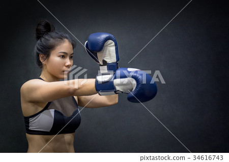 young Asian woman posing with boxing gloves 34616743