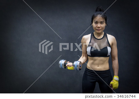 Young Asian woman lifting dumbbell,weight training 34616744