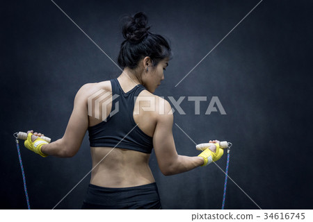 Asian sport girl doing exercises with jumping rope 34616745