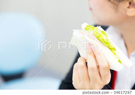 Female employee OL businessman eating at the desk 34617297