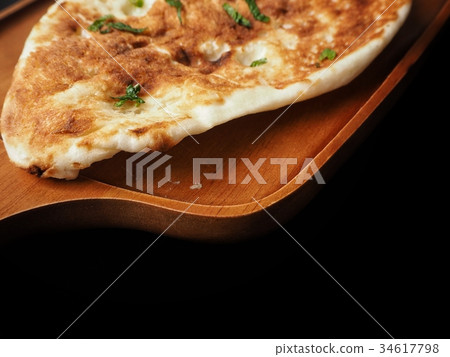 Indian naan bread on black background 34617798
