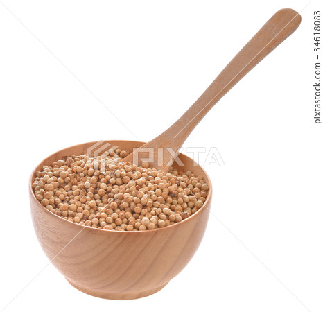 Coriander seeds in wooden bowl on white background Coriander seeds in wooden bowl on white background 34618083