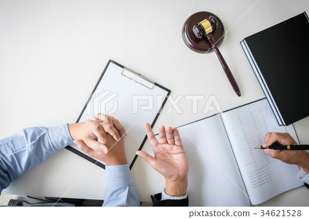 Close up of gavel, Male lawyer or judge Consult with client and 34621528