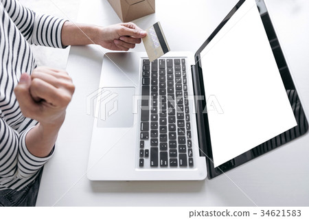 Woman's hands using credit card register and payments online sho 34621583