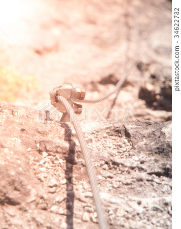 Close-up view of bolt via ferrata cable fastening Close-up view of bolt via ferrata cable fastening 34622782