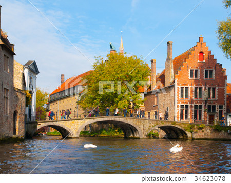 Water canal with old bridge and medieval houses at 34623078