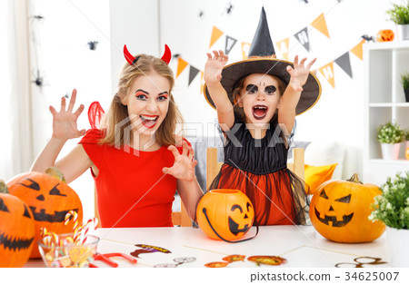 family mother and child in costumes  for halloween 34625007
