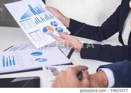 Business team two executive colleagues discussing and analysis w Business team two executive colleagues discussing and analysis w 34625477