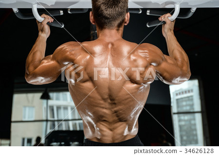 Handsome model young man training back in gym 34626128