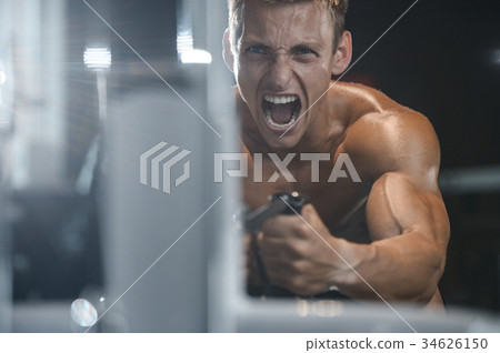 Handsome model young man working out in gym Handsome model young man working out in gym 34626150
