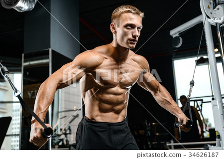 Brutal Caucasian bodybuilder training chest in gym Brutal Caucasian bodybuilder training chest in gym 34626187