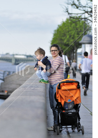 Mother and son stand on the embankment in Sankt Petersburg Mother and son stand on the embankment in Sankt Petersburg 34629492
