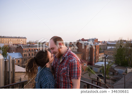 Kissing casual couple on roof. Romantic place 34630681