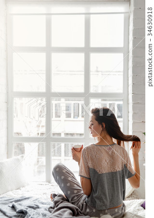 Sensual young woman with cup of tea Sensual young woman with cup of tea 34630918