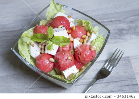 Salad with feta cheese, watermelon and pine nuts. 34631462