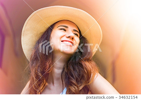 Girl with hat on summer day in the street. Girl with hat on summer day in the street. 34632154