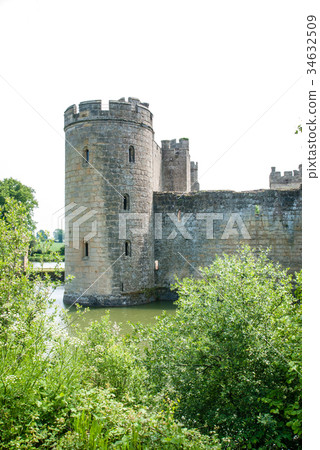 An old castle surrounded by a pond outside England An old castle surrounded by a pond outside England 34632509
