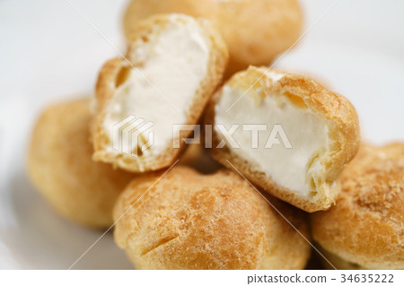 profiteroles on plate closeup one sliced 34635222