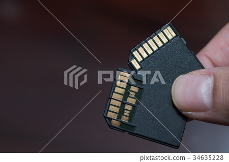 hand holding sd card uhs i and uhs ii hand holding sd card uhs i and uhs ii 34635228