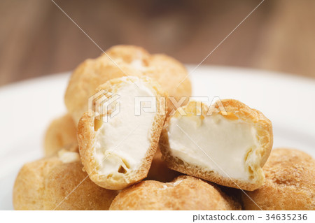 profiteroles on plate closeup one sliced profiteroles on plate closeup one sliced 34635236