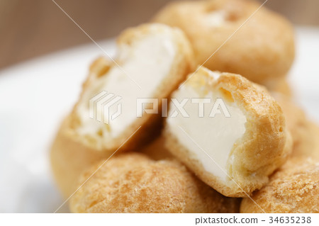 profiteroles on plate closeup one sliced profiteroles on plate closeup one sliced 34635238