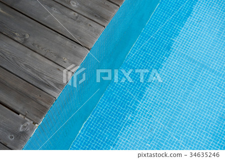 wooden plank pier with blue water in the pool wooden plank pier with blue water in the pool 34635246