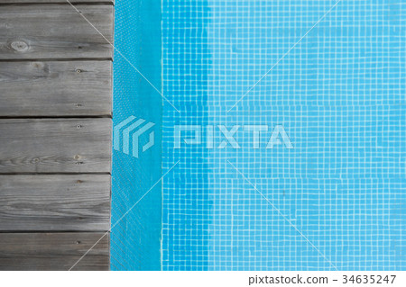 wooden plank pier with blue water in the pool wooden plank pier with blue water in the pool 34635247