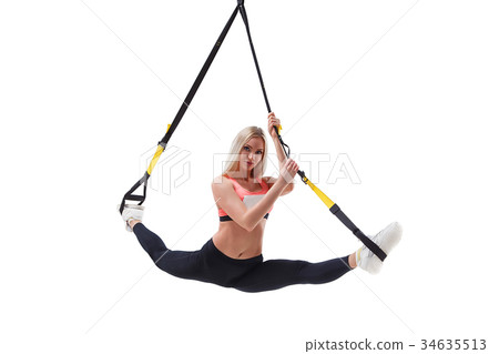 Woman doing a split with TRX Woman doing a split with TRX 34635513