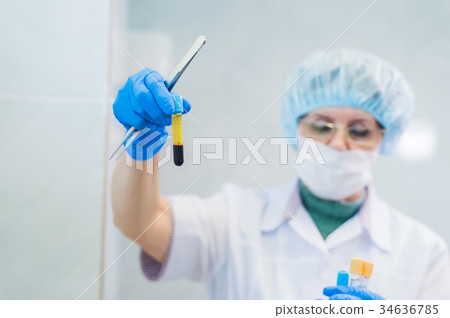 Closeup of a senior female chemist setting up some Closeup of a senior female chemist setting up some 34636785