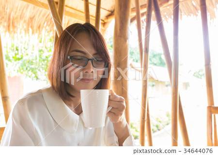 Asian woman drink coffee. Asian woman drink coffee. 34644076
