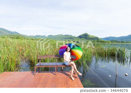 Woman sitting at the bench 34644078