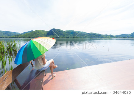 Woman sitting at the bench 34644080